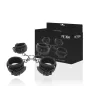 Preview: Black handcuffs and leg irons with chains, in front of a package printed with "Fetish Submissive".