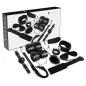Preview: Schwarzes Bondage-Set mit Fesseln, Augenbinde, Ballknebel, Peitsche und weiteren Accessoires vor Verpackung.