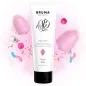 Preview: Tube of aloe vera gel surrounded by cotton candy, lollipops and colorful sprinkles on a white background.