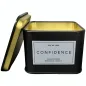 Preview: Schwarze Dose mit offenem Deckel, Aufschrift: "Eye of Love Confidence Pheromone Massage Candle".