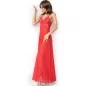 Preview: Person in a long red dress with a lace top, standing sideways, wearing a necklace and white shoes.