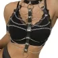 Preview: Woman wears black leather and chain harness over black top.