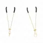 Preview: Two golden nipple clamps with black rubber tips on a white background.