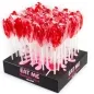 Preview: Red lollipops in plastic packaging on a black display with the inscription "EAT ME Strawberry Jelly Lollipop".