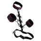 Preview: Black and red handcuffs and leg irons with connecting straps and buckles.