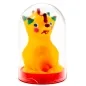 Preview: Yellow clay figure with a colorful face and crown in a transparent dome on a red base.