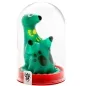 Preview: Green, polka-dotted toy in the shape of an animal under a transparent dome with a red base.