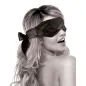 Preview: A woman with long hair is wearing a black blindfold and smiling over her shoulder.