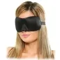 Preview: A woman with blonde hair is wearing a black sleep mask.