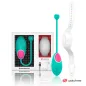 Preview: Turquoise wearable with pink accents, white strap, and USB cable included in the packaging. Brand: Watchme.