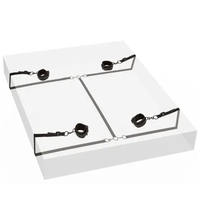 Black restraints with straps on a mattress, fastened in the four corners.