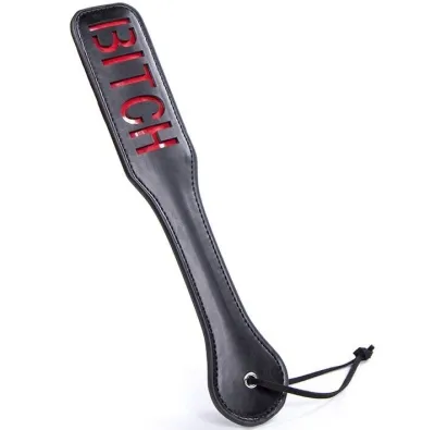 Black leather paddle with the word "BITCH" in red lettering and a loop at the end of the handle.
