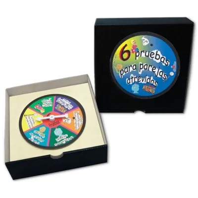 A game with a rotating disc in a box, labeled "6 pruebas para parejas atrevidas".