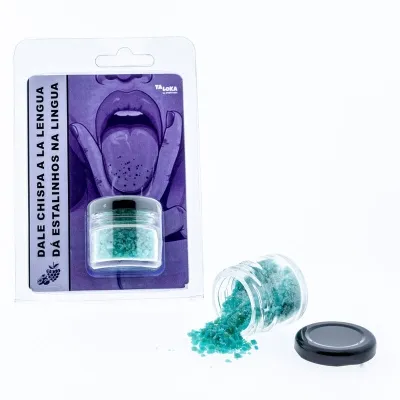 Kleines Glas mit blauen Kristallen, daneben Verpackung mit Zunge-Illustration und Text in Spanisch und Portugiesisch.