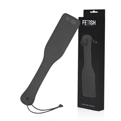 Black paddle with the word "Fetish" written on it and packaging in the background.