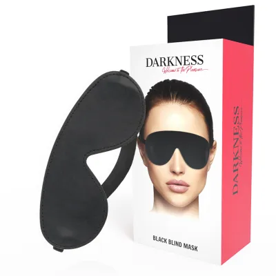 Black eye mask next to packaging with a picture of a person wearing the mask. Text: "Darkness Black Blind Mask".