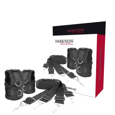 Black bondage set with Velcro fasteners and metal rings, packaged in a box labeled "Darkness".
