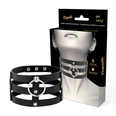 Black, handmade choker necklace made of vegan leather with a silver ring, shown in front of the packaging.