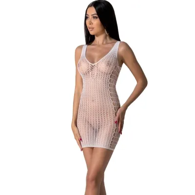 Woman in a white, see-through mesh dress with a geometric pattern, posing in front of a white background.
