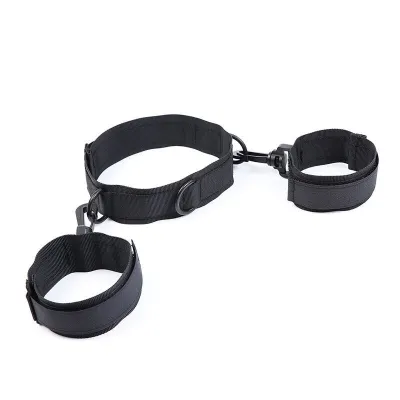 Black fabric handcuffs and leg irons with adjustable straps and metal rings on a white background.