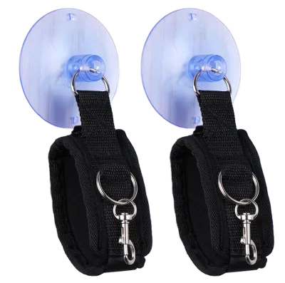 Two black handcuffs with suction cups and metal rings, arranged side by side.