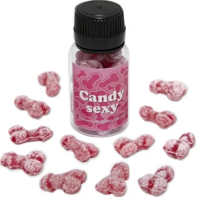 A bottle containing pink, penis-shaped candies labeled "Candy Sexy". Candies are scattered around the bottle.