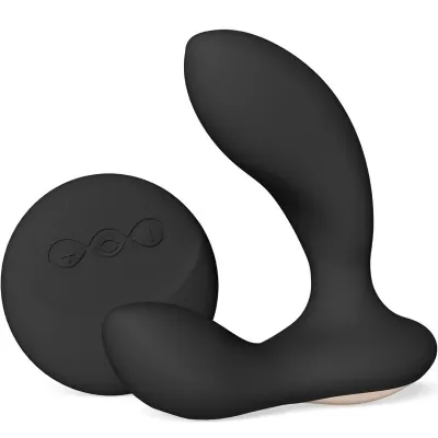 Black, ergonomically shaped massage device with remote control, both made of silicone.