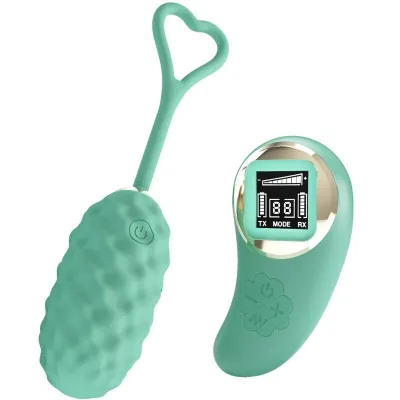 Green, textured vibrating toy with remote control and display, heart-shaped handle on top.