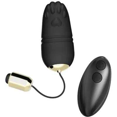 Black, egg-shaped massage device with paw print pattern and remote control, gold accents.
