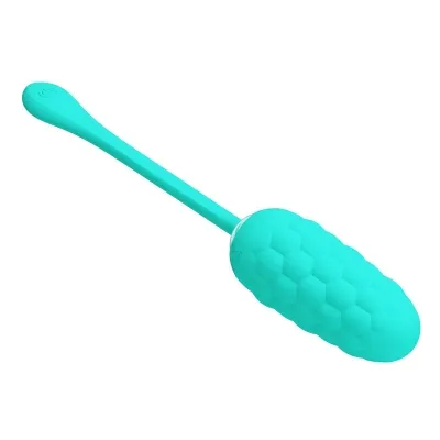 Turquoise, elongated massage device with a honeycomb structure and long handle.