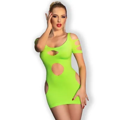 Person in a neon green dress with cut-outs, posing in front of a white background.
