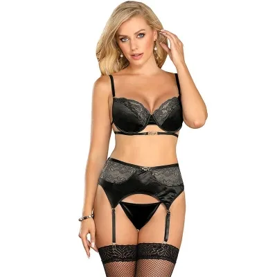 Woman in black lace lingerie with stockings and garter belts against a white background.