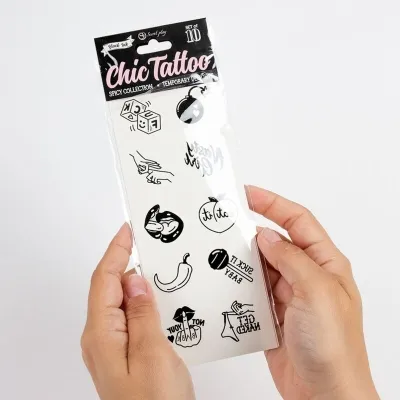 A person is holding a set of temporary tattoos with various designs.