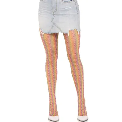 A person is wearing a denim skirt and colorful tights with white shoes.