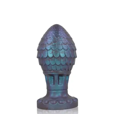 Blue-purple decorative object in the shape of a pine cone with a scale pattern on a white background.