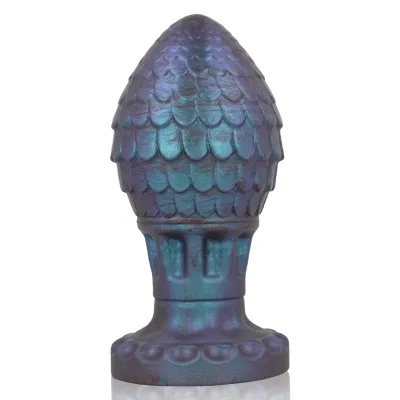 Blue-violet, cone-shaped sculpture with a scale-like surface and a wide base.
