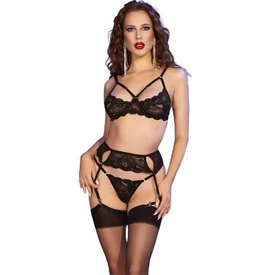 Woman in black lace lingerie with garter belt and earrings against a white background.