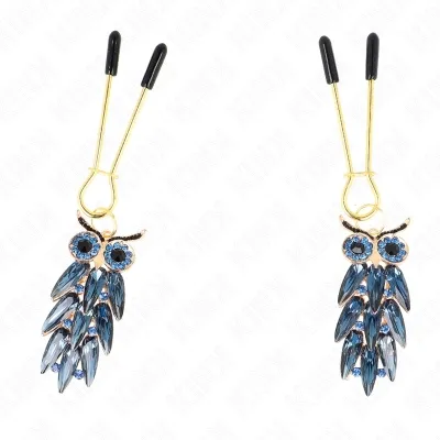 Two owl earrings with blue crystals and gold details, on gold hooks with black ends.