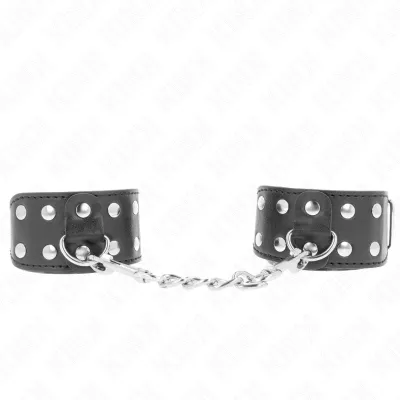 Black leather handcuffs connected with metal rivets and chain.