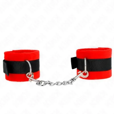 Red plush handcuffs with black ribbon and silver chain, on a white background.