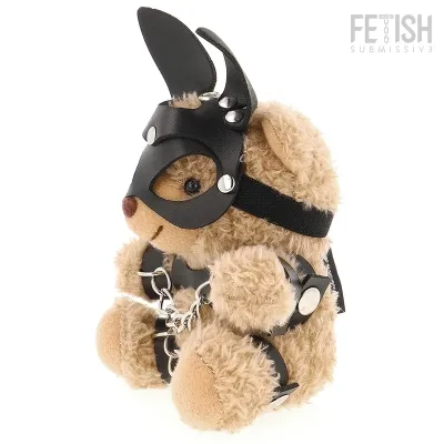 Teddy bear in black leather outfit with mask and chains, sitting upright.