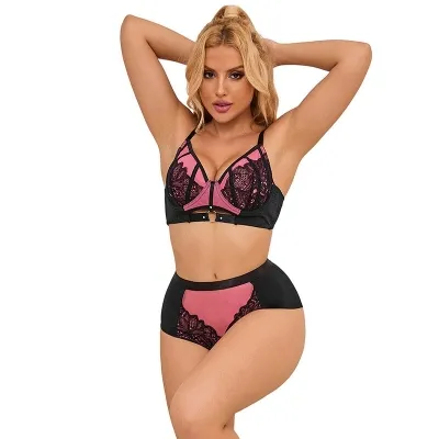 Woman in black and pink lace lingerie, posing with raised arms.