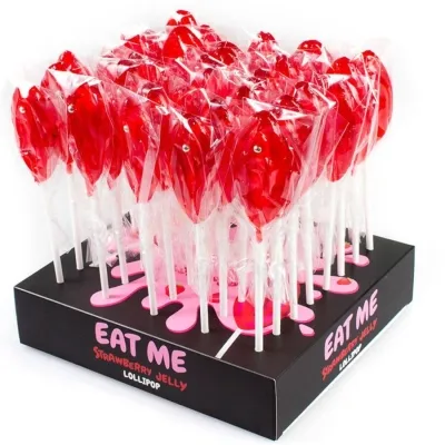 Red lollipops in plastic packaging on a black display with the inscription "EAT ME Strawberry Jelly Lollipop".