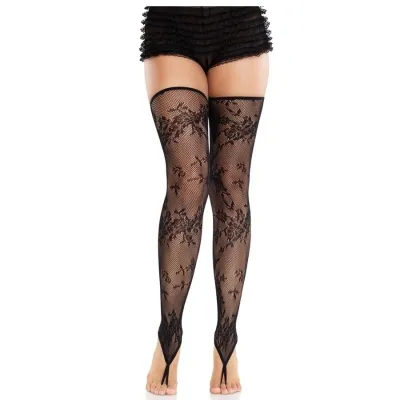 Woman wearing black lace stockings and frilly shorts, standing barefoot on a white background.