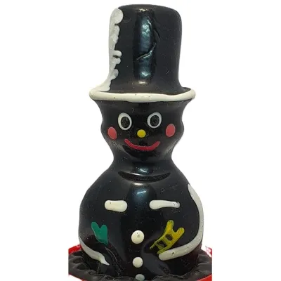 Chocolate figure of a chimney sweep with top hat, colorful details and smiling face.