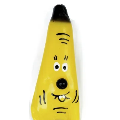 Yellow banana toy with a face, big eyes, black nose and smiling mouth on a white background.