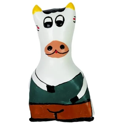 Colorful, cartoon-like cow figure with yellow horns, large eyes and green clothing.