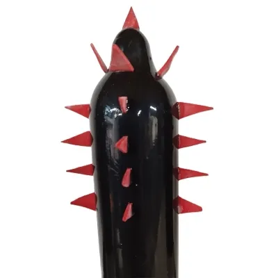 Black object with red, pointed spikes on the sides and top.