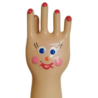 Hand-shaped figure with a face, blue eyes, pink cheeks and red lips, fingernails painted red.