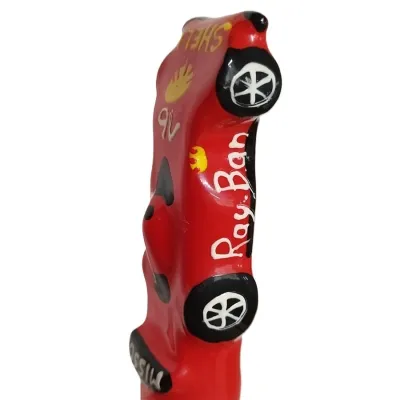 Red model car with the inscriptions "Ray Ban" and "Shell", black wheels, decorative painting.
